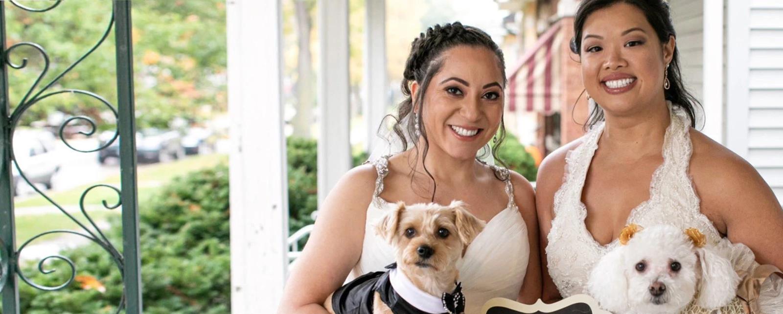 Two Women In Dresses With Dogs