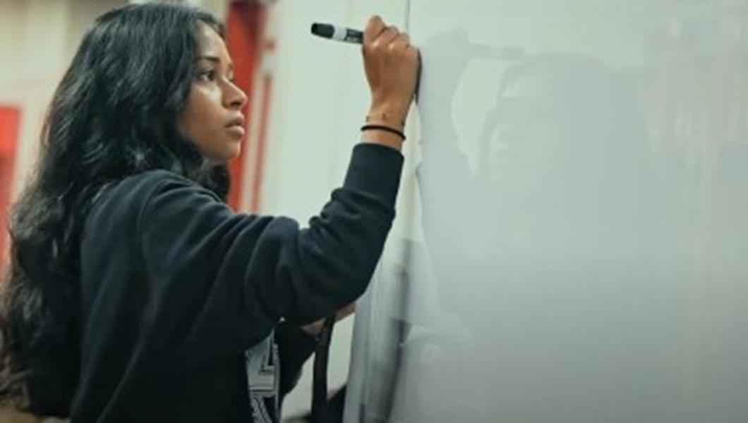 Older Teen Girl Writing On A Whiteboard