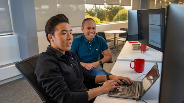 Verizon employee on computer.