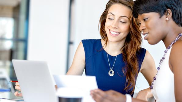 Two women reviewing interview materials