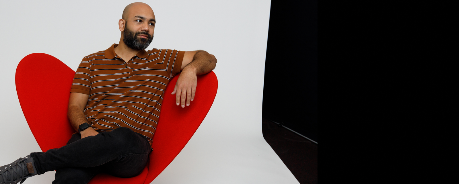 Man With Beard Posing On A Red Chair