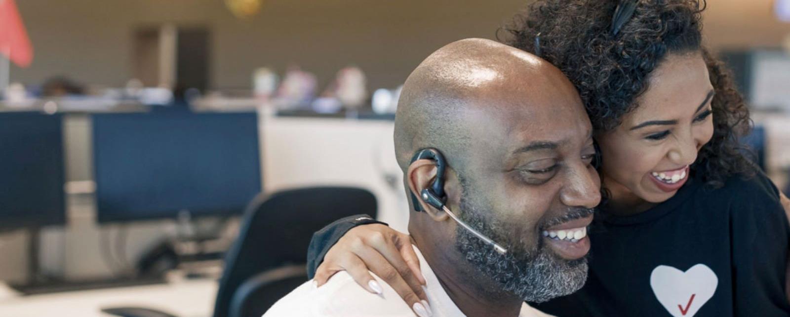 Two Customer Support Employees Having Fun At Work (1)