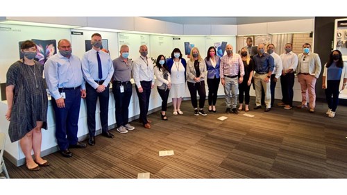 Patty photographed with members of her sales team during a Boston employee roundtable.