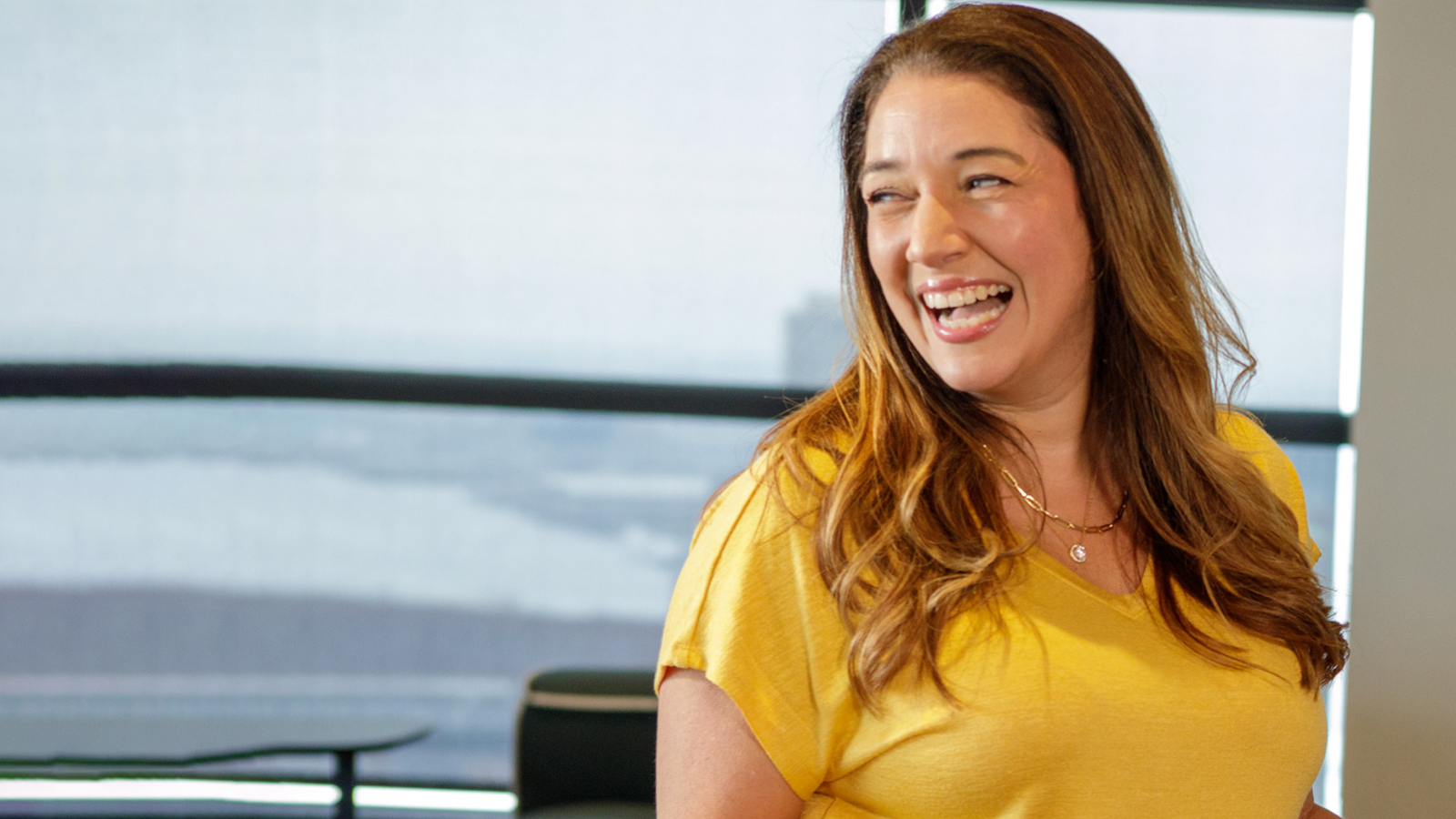 Red Headed Woman Looking Back And Laughing In Open Office